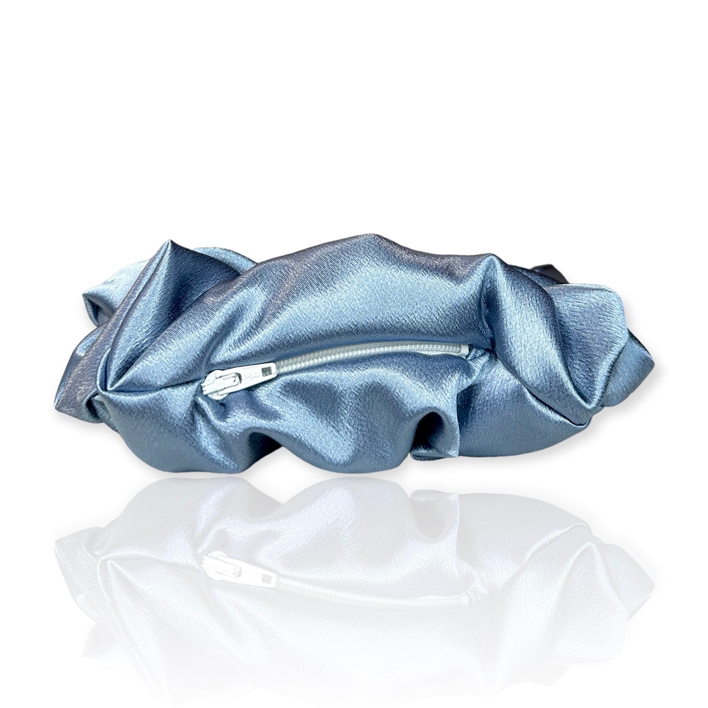 With Pocket: A close-up of a Luxe XL Cinderella scrunchie with a shimmering fabric and a small pocket, perfect for storing essentials.
Without Pocket: A close-up of a Luxe XL Cinderella scrunchie with a shimmering fabric, showcasing its elegant design and luxurious
